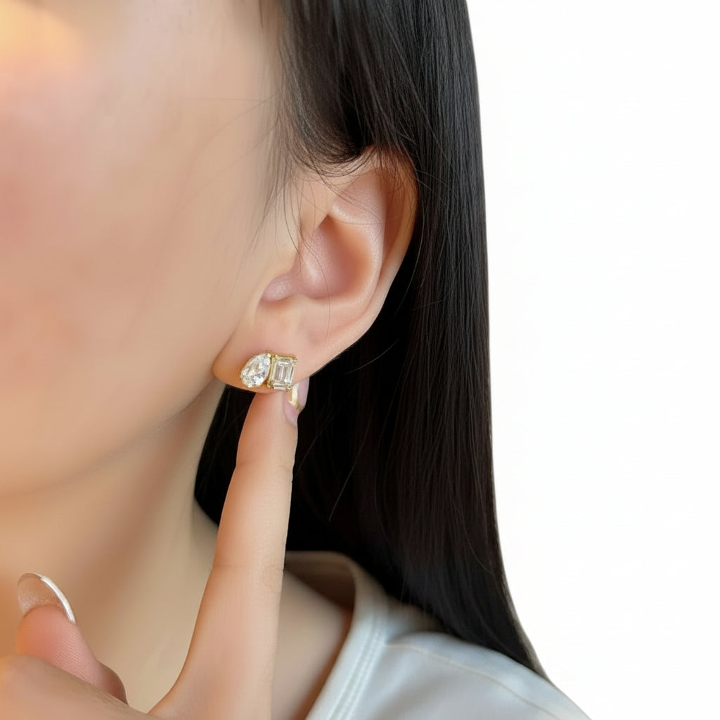 Close-up of a person wearing a diamond earring with a white background