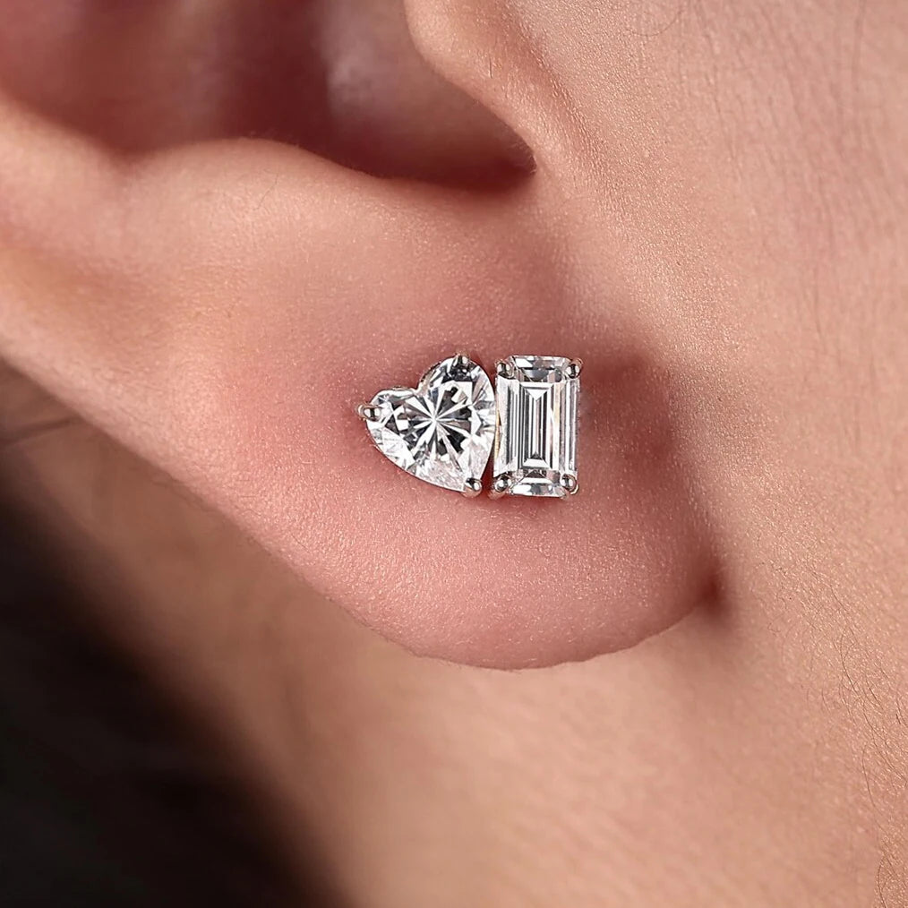 Close-up of a moissanite diamond earring on an ear lobe.