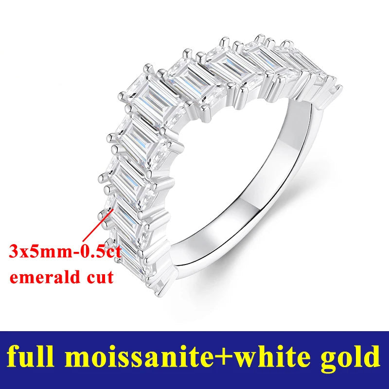 Silver ring with emerald cut moissanite stones on a white background