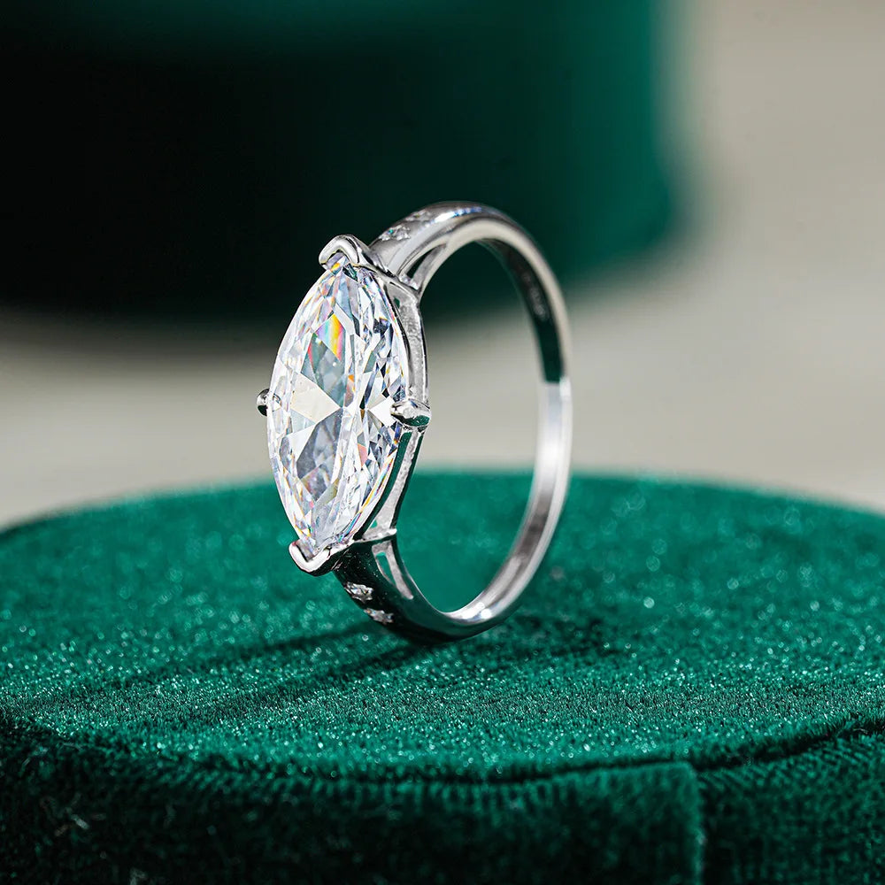 Silver ring with a large moissanite on a green cushion