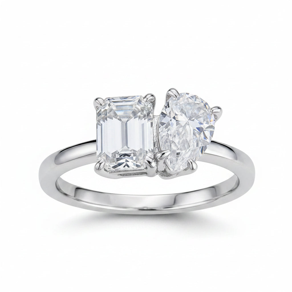 Diamond ring with two large gemstones on a white background