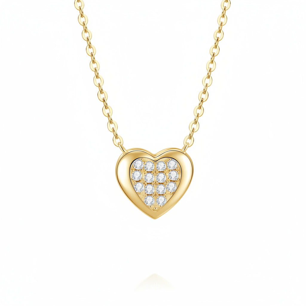 Gold heart-shaped necklace with embedded moissanites on a white background