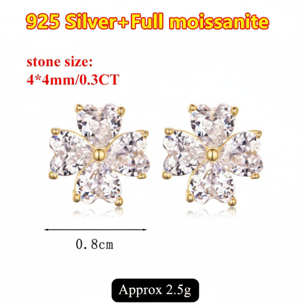 Pair of silver and gold earrings with moissanite stones, labeled with stone size and weight.