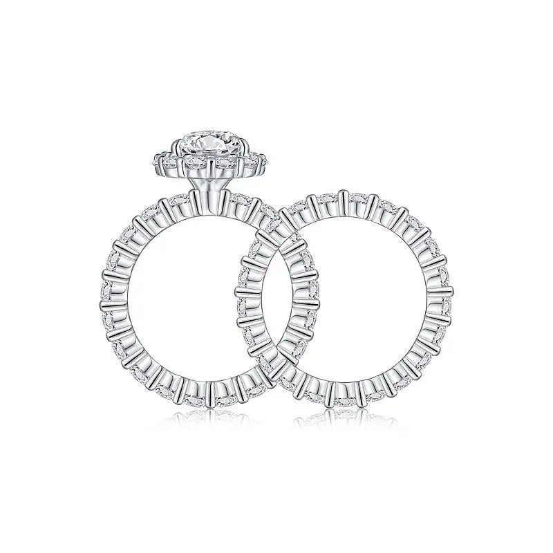 Moissanite ring with a halo and baguette cut stones on a white background