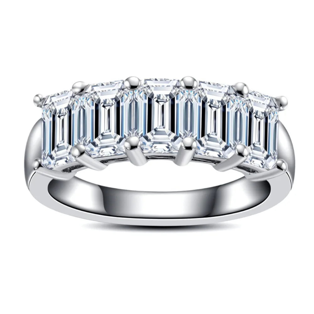 Moissanite ring with emerald-cut stones on a white background