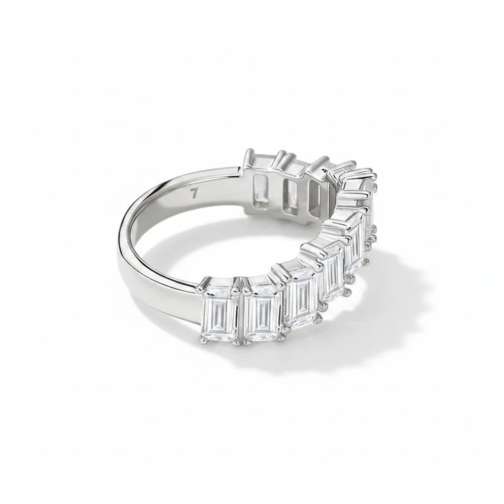 Silver ring with emerald-cut moissanite on a white background