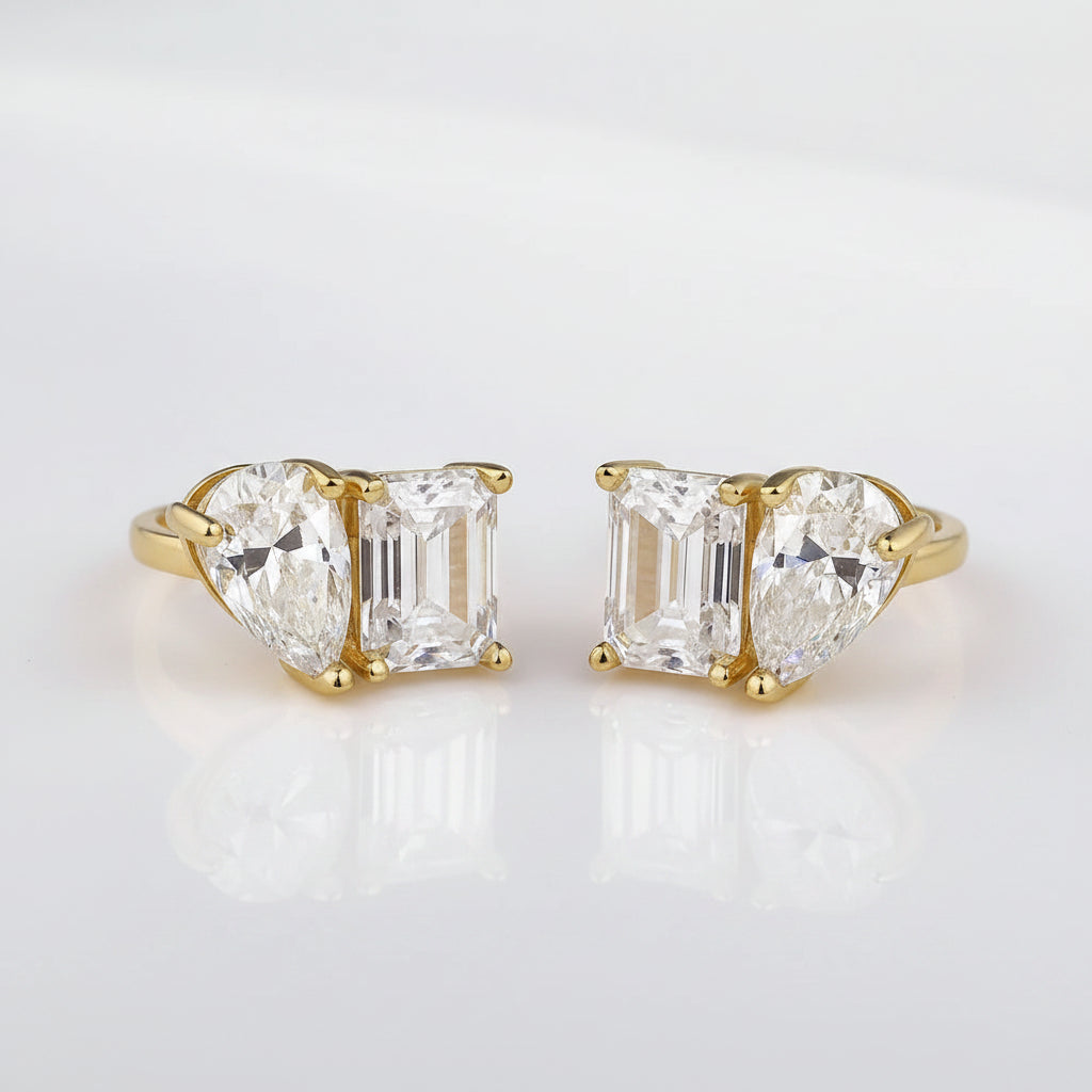 Gold earrings with moissanite gemstones on a white background