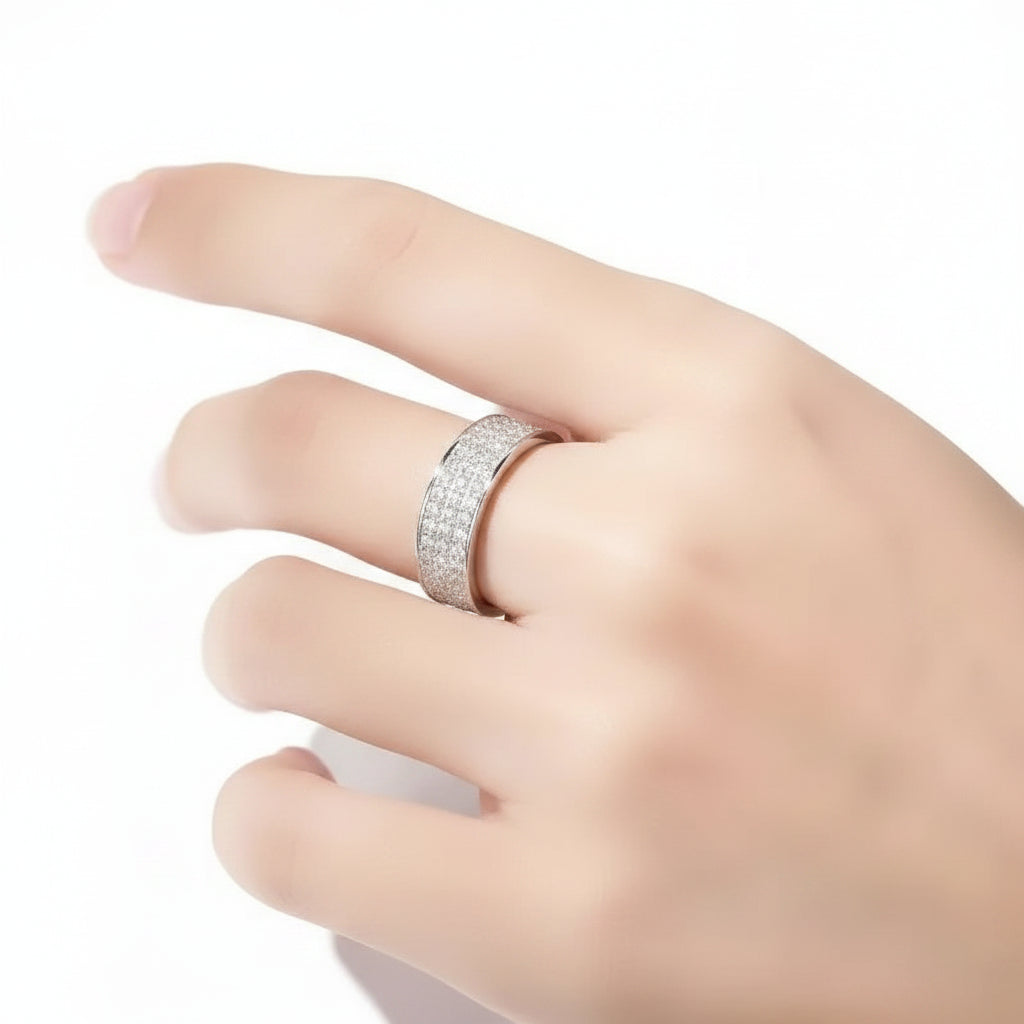 Silver ring on a finger with a blurred white background