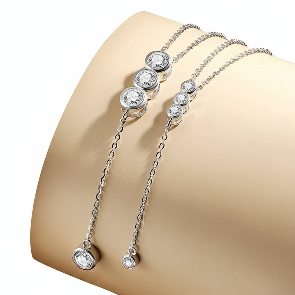 Silver bracelet with gemstones on a beige surface with a white background