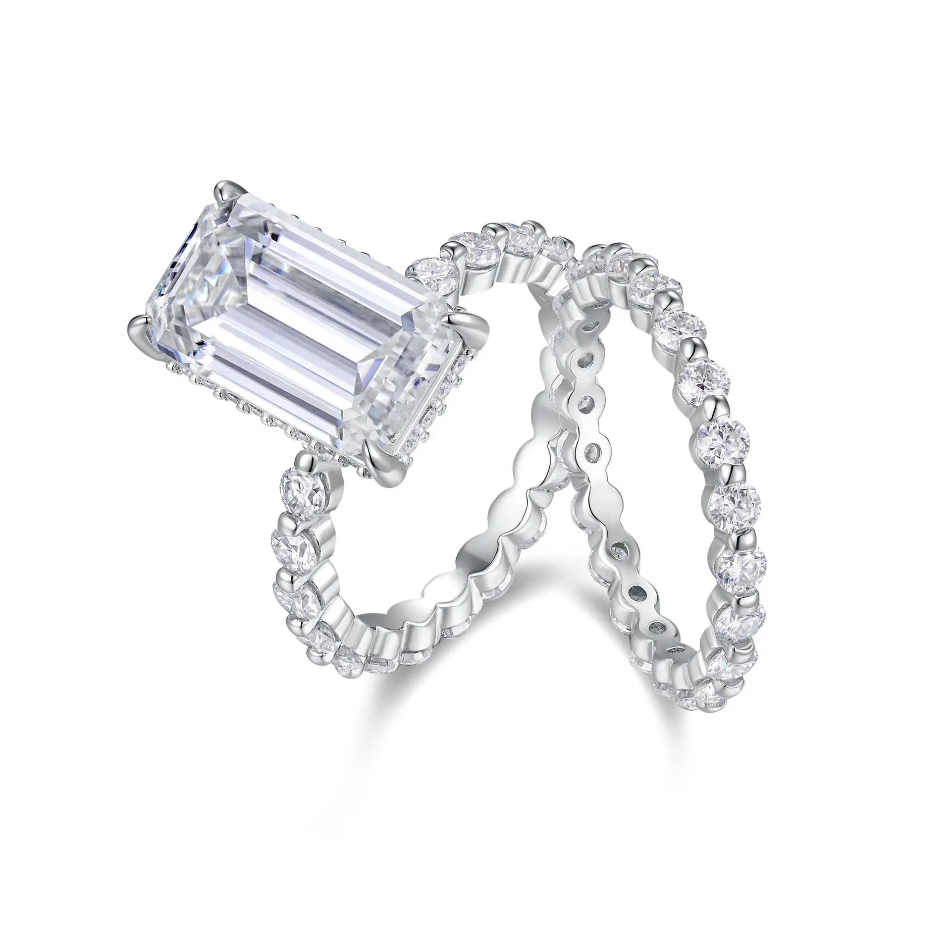 Moissanite diamond ring with emerald-cut center stone and matching band on a white background