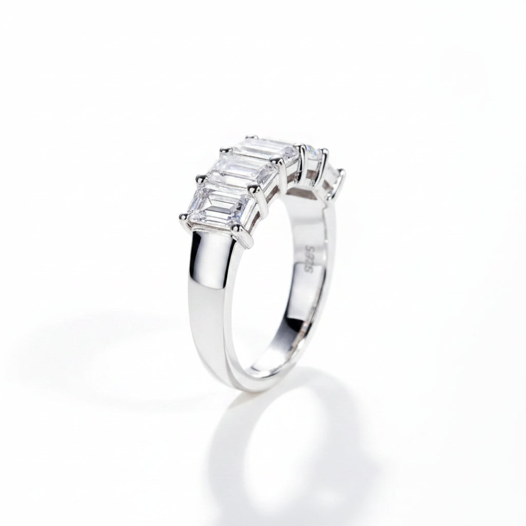 Silver ring with emerald-cut moissanite diamond on a white background