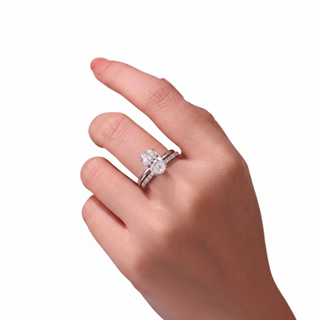 Close-up of a hand wearing a diamond ring with a white background