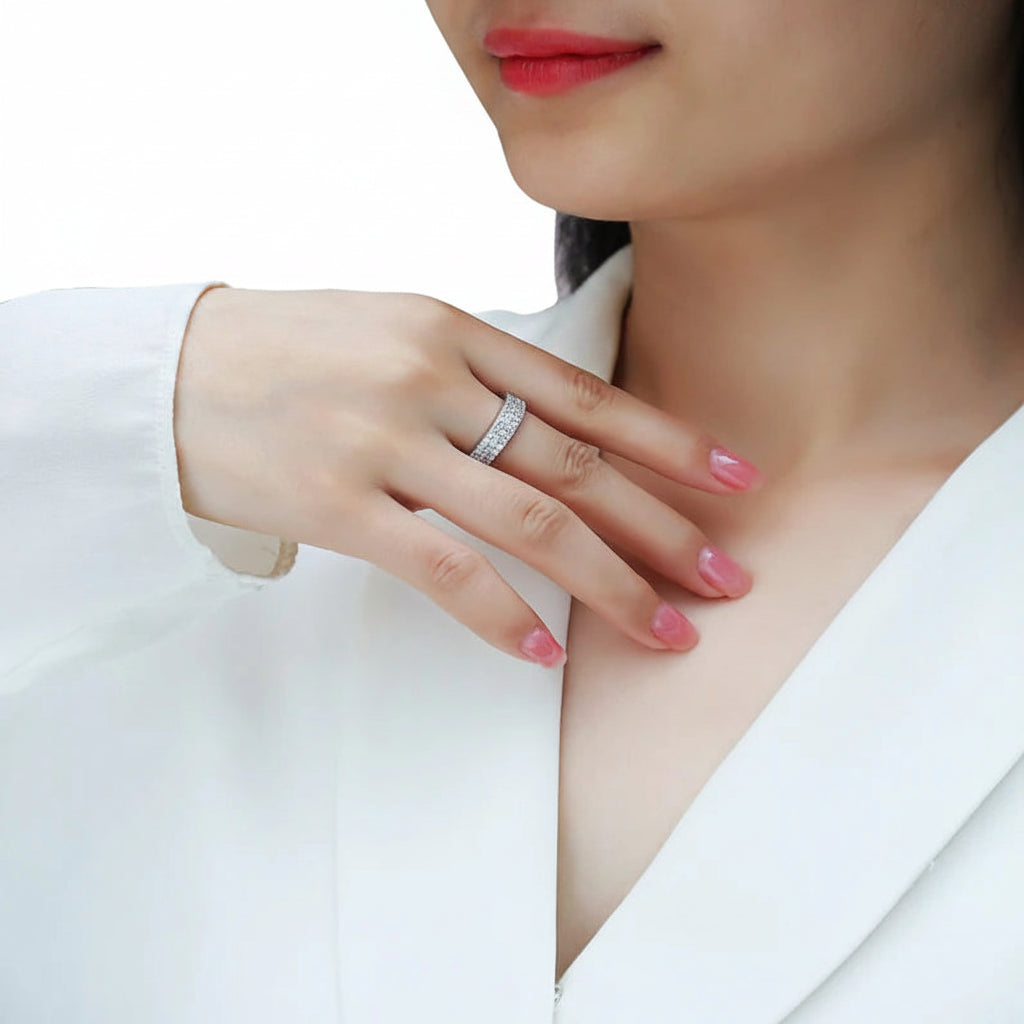 Close-up of a woman's hand wearing a ring with a blurred background