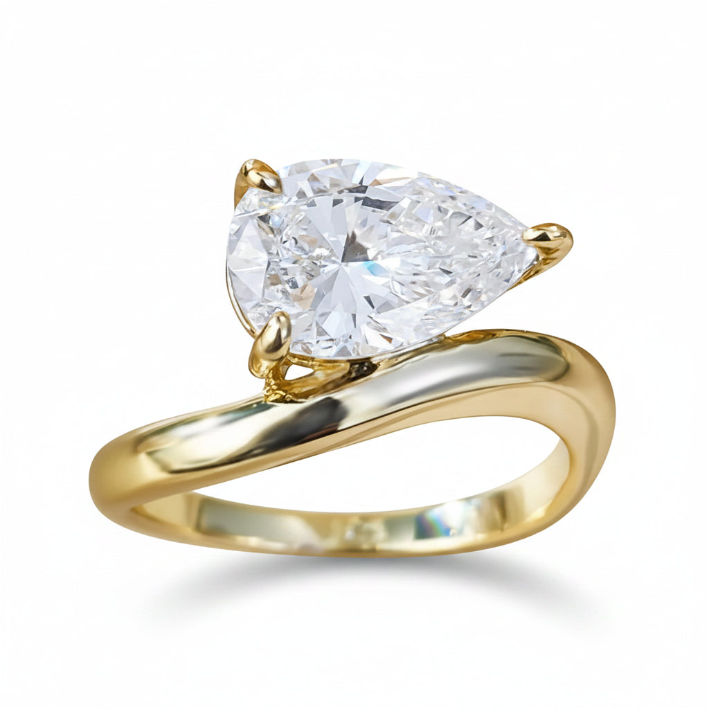 Gold ring with a large moissanite on a white background.
