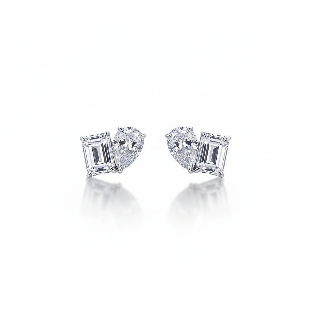 Pair of diamond earrings on a white surface