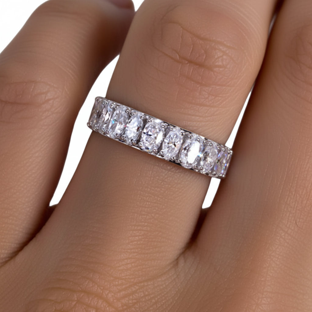 Moissanite ring on a finger.
