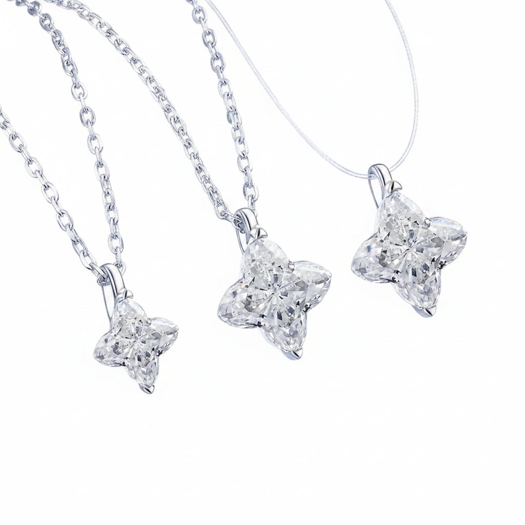 Three star-shaped silver pendants on a white background
