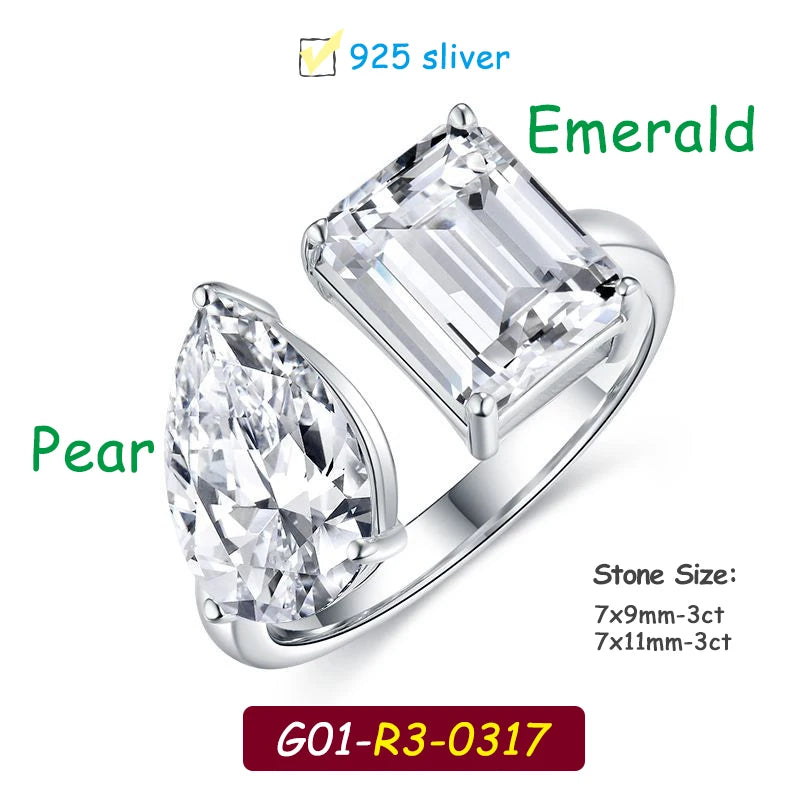 Silver ring with emerald and pear-shaped gemstones on a white background