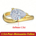 Gold ring with pear-shaped moissanite on a white background
