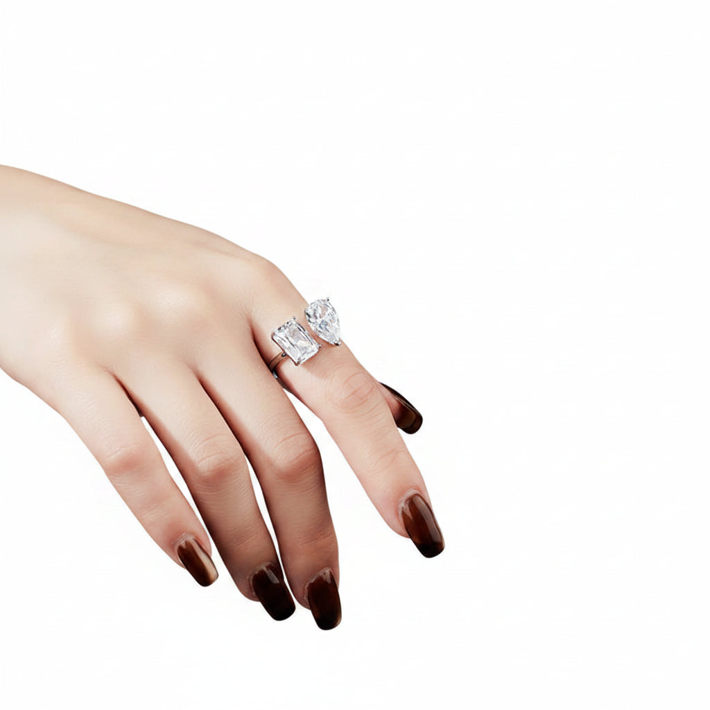 Hand wearing a moissanite ring with a white background