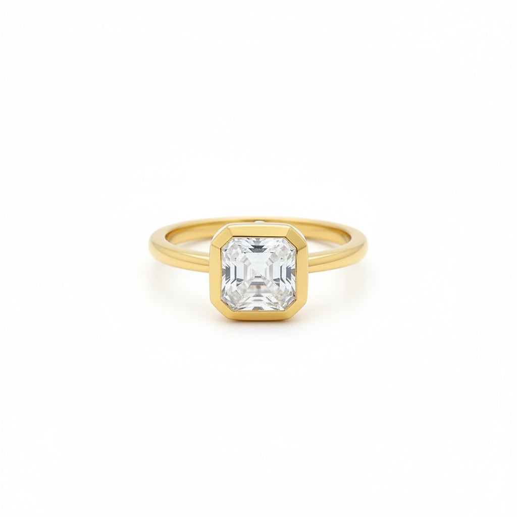 Gold ring with a asscher moissanite diamond on a white surface