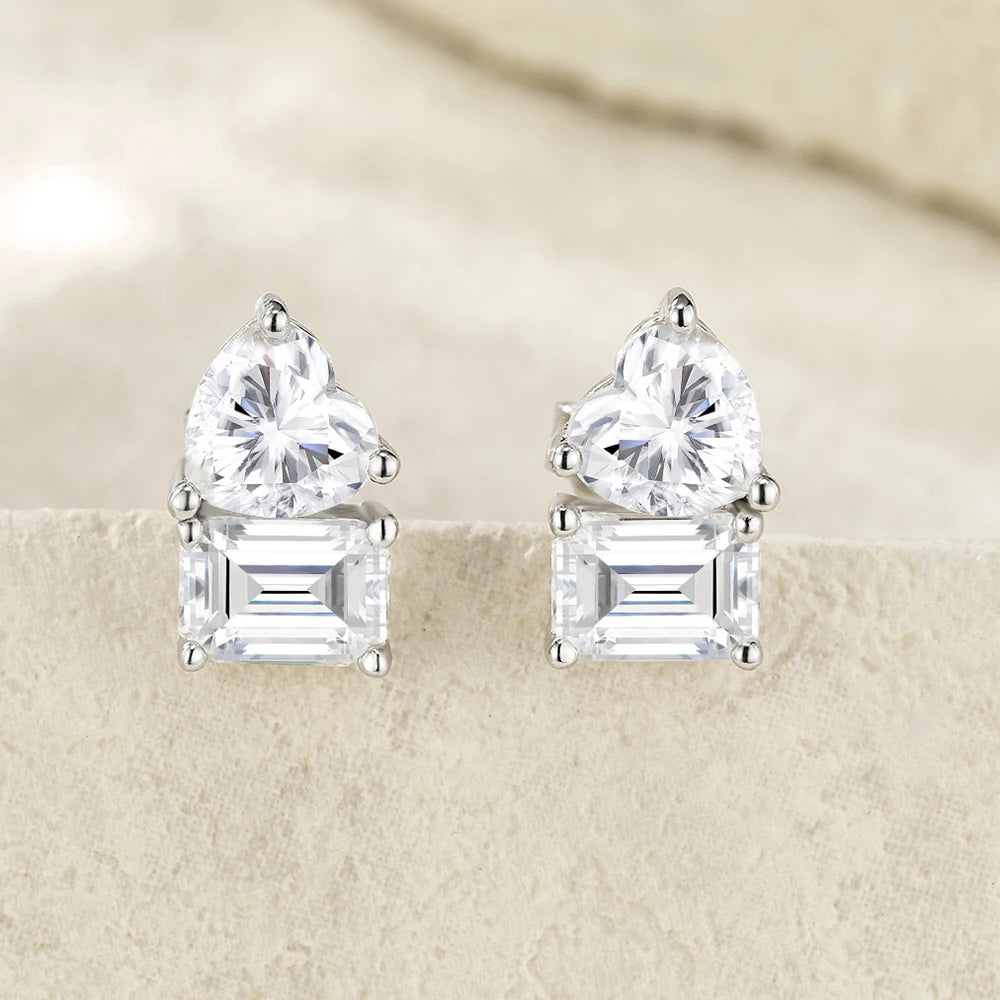 Pair of diamond stud earrings on a beige background
