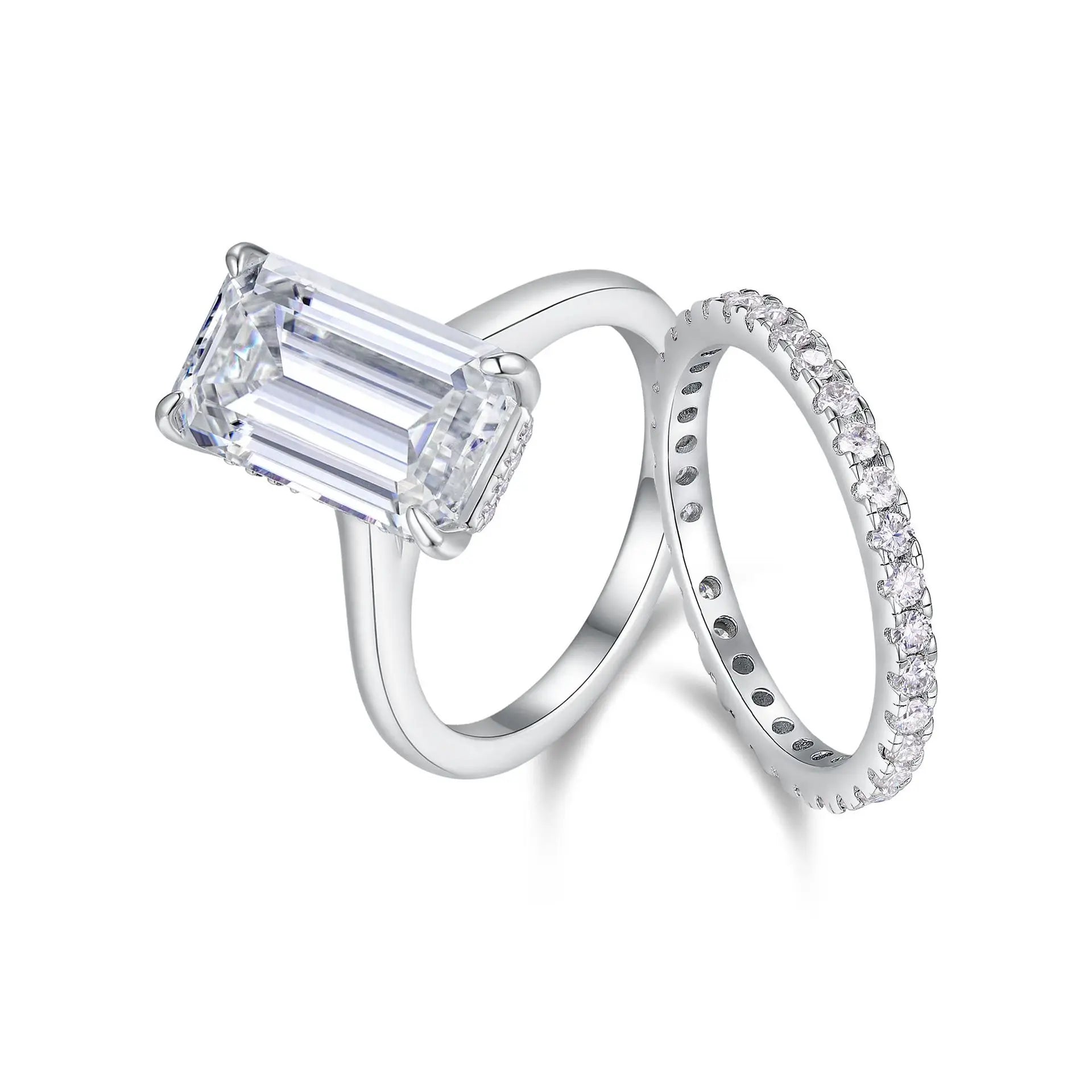 Diamond ring with emerald-cut center stone and matching band on a white background