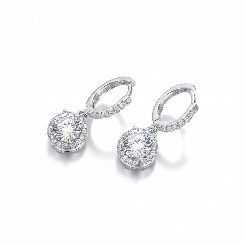 Pair of silver earrings with round gemstones on a white background