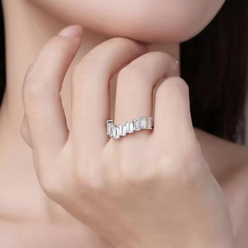 Close-up of a hand wearing a moissanite ring.