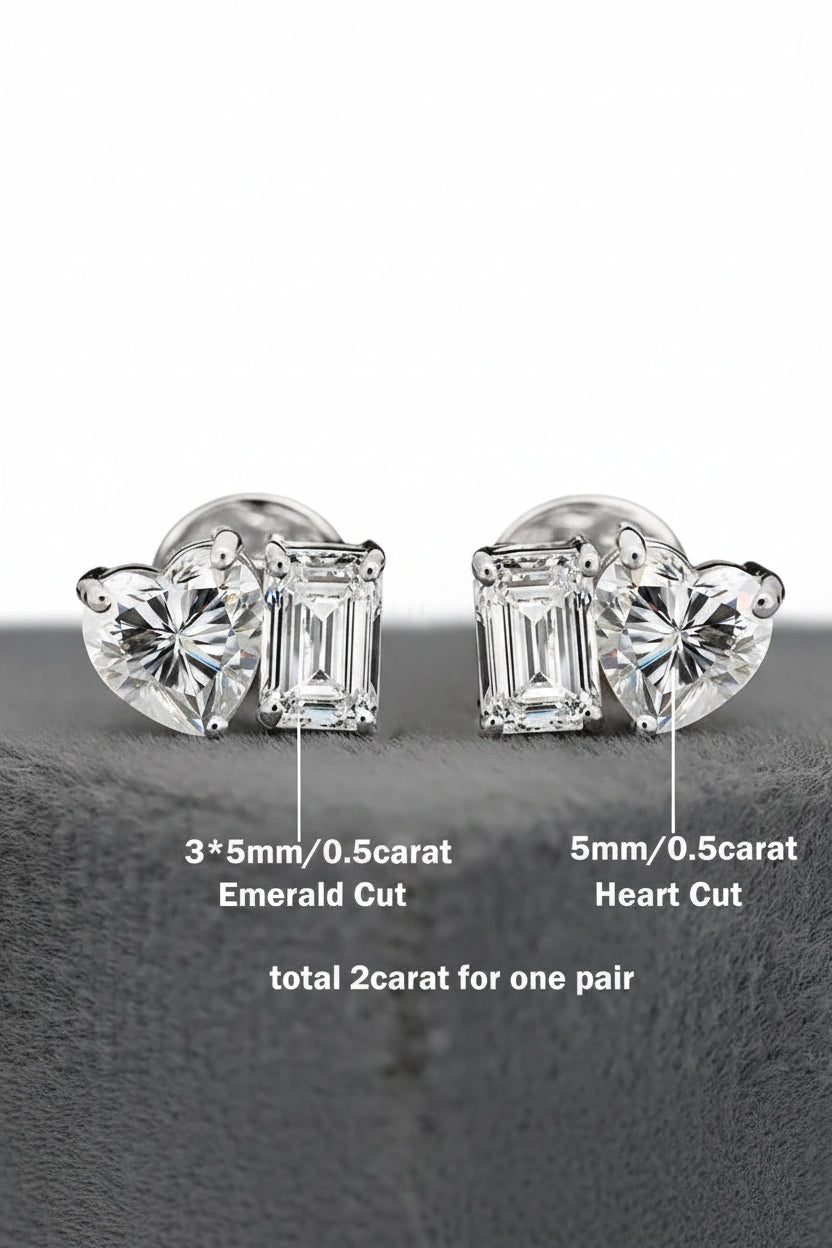 Pair of diamond earrings with heart and emerald cut stones on a white background