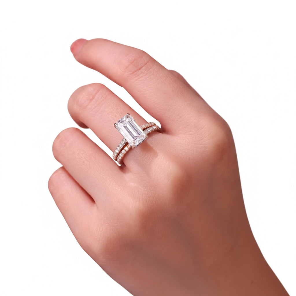 Close-up of a hand wearing a diamond ring with a white background
