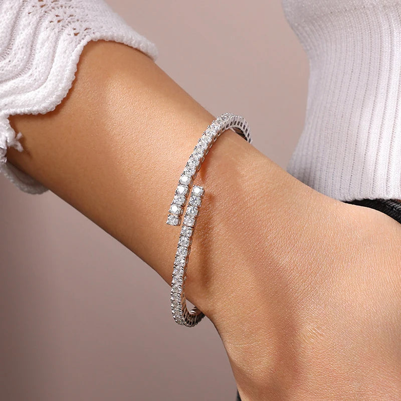 Moissanite silver bracelet on a person's wrist with a neutral background