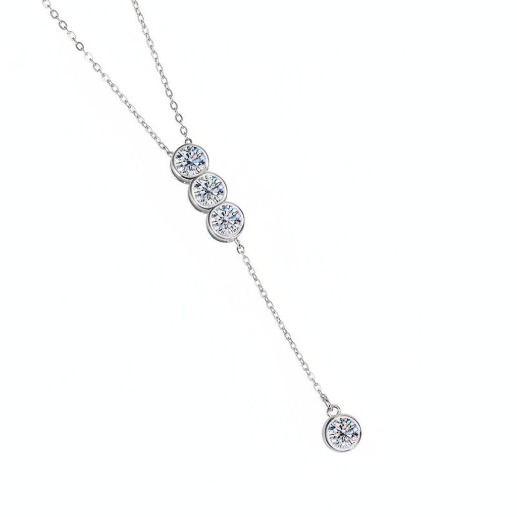 Silver necklace with four round gemstones on a white background
