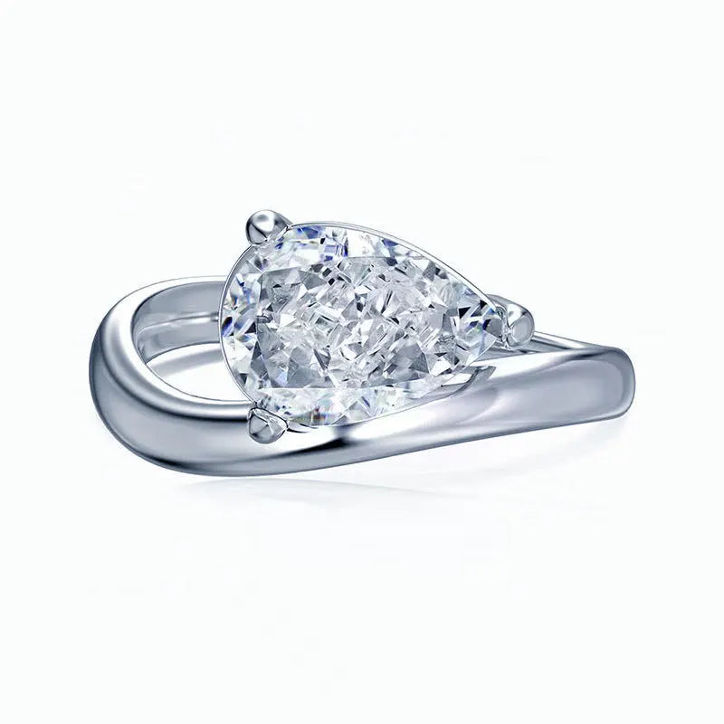 Diamond ring with a pear-shaped moissanite gemstone on a white background