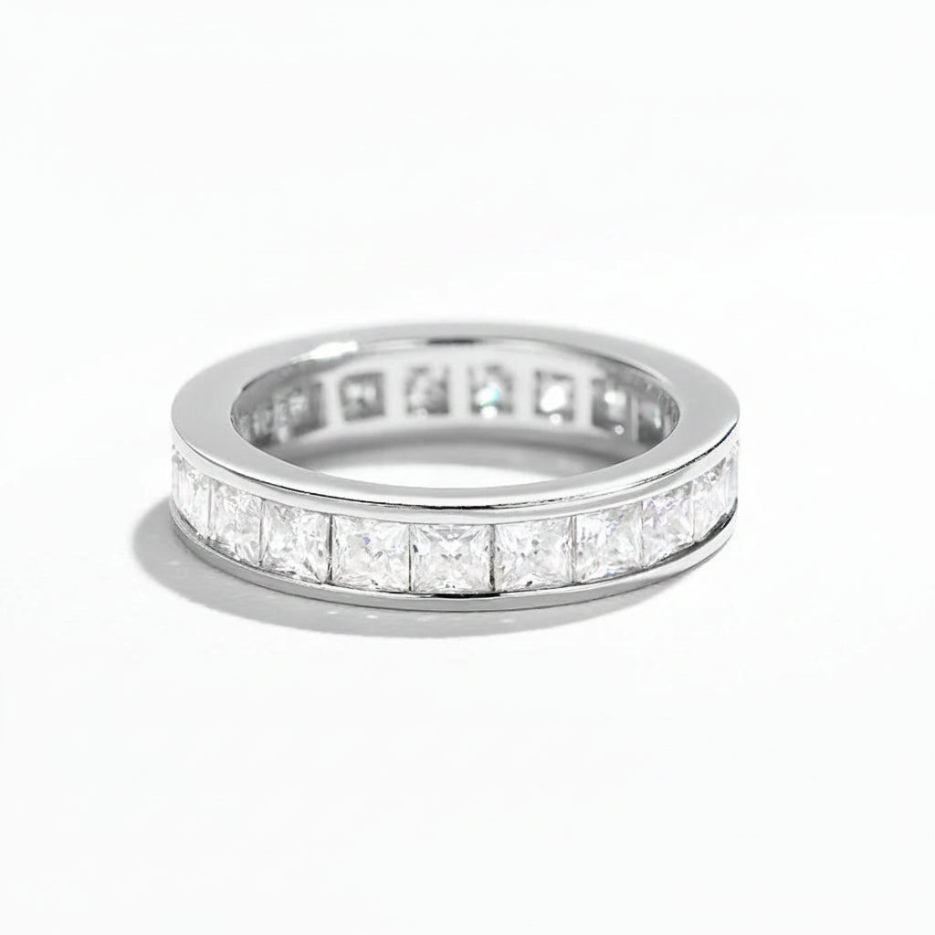 Silver ring with moissanite stones on a white background
