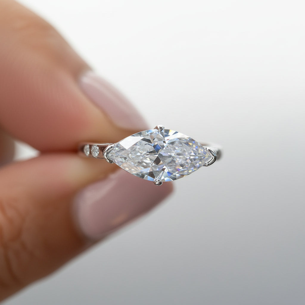 Moissanite ring held by a hand against a blurred background