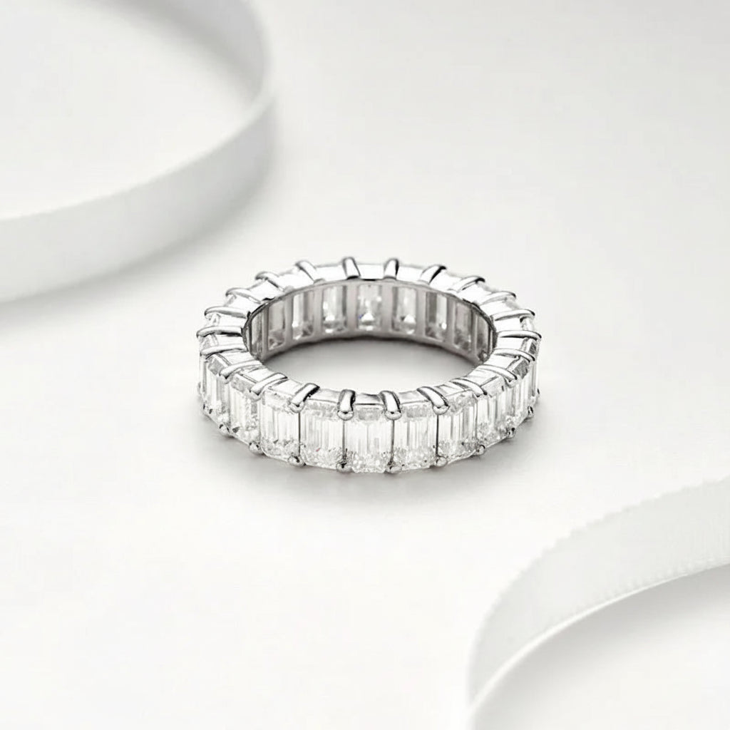 Moissanite ring with baguette-cut stones on a white background