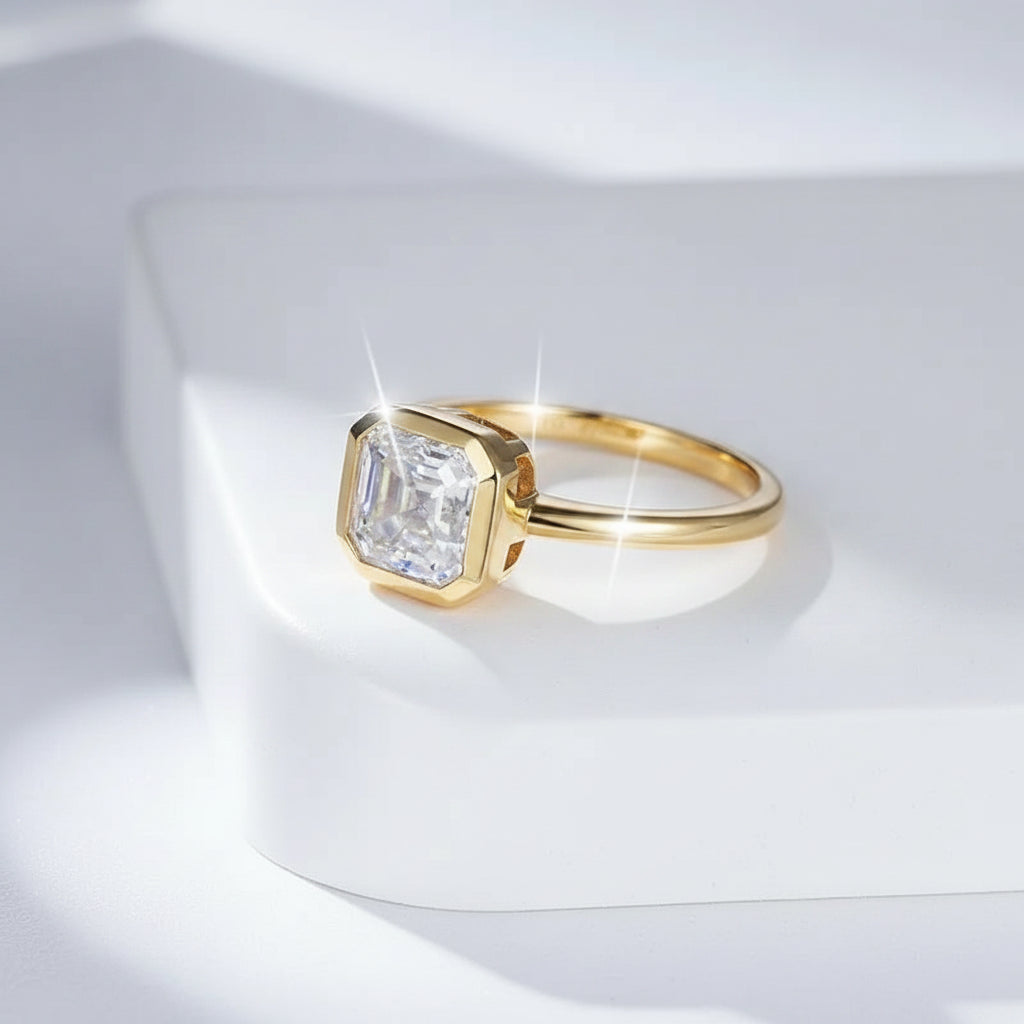 Gold ring with a large asscher diamond on a white background