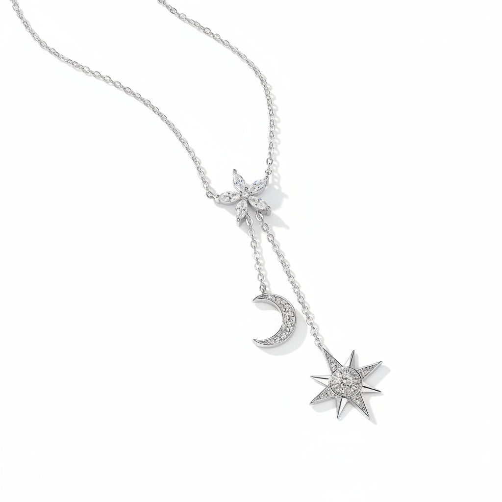 Silver necklace with star, moon, and flower pendants on a white background