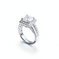 Silver ring with a large diamond and smaller diamonds on a white background