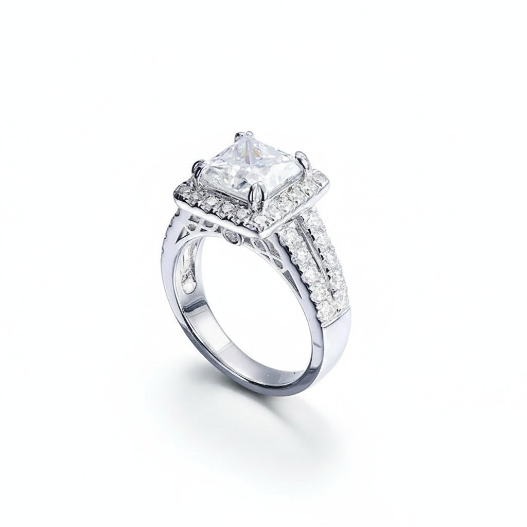 Silver ring with a large diamond and smaller diamonds on a white background