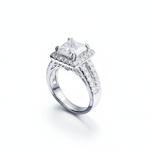 Silver ring with a large diamond and smaller diamonds on a white background