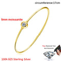 Gold bracelet with moissanite gemstone on a white background