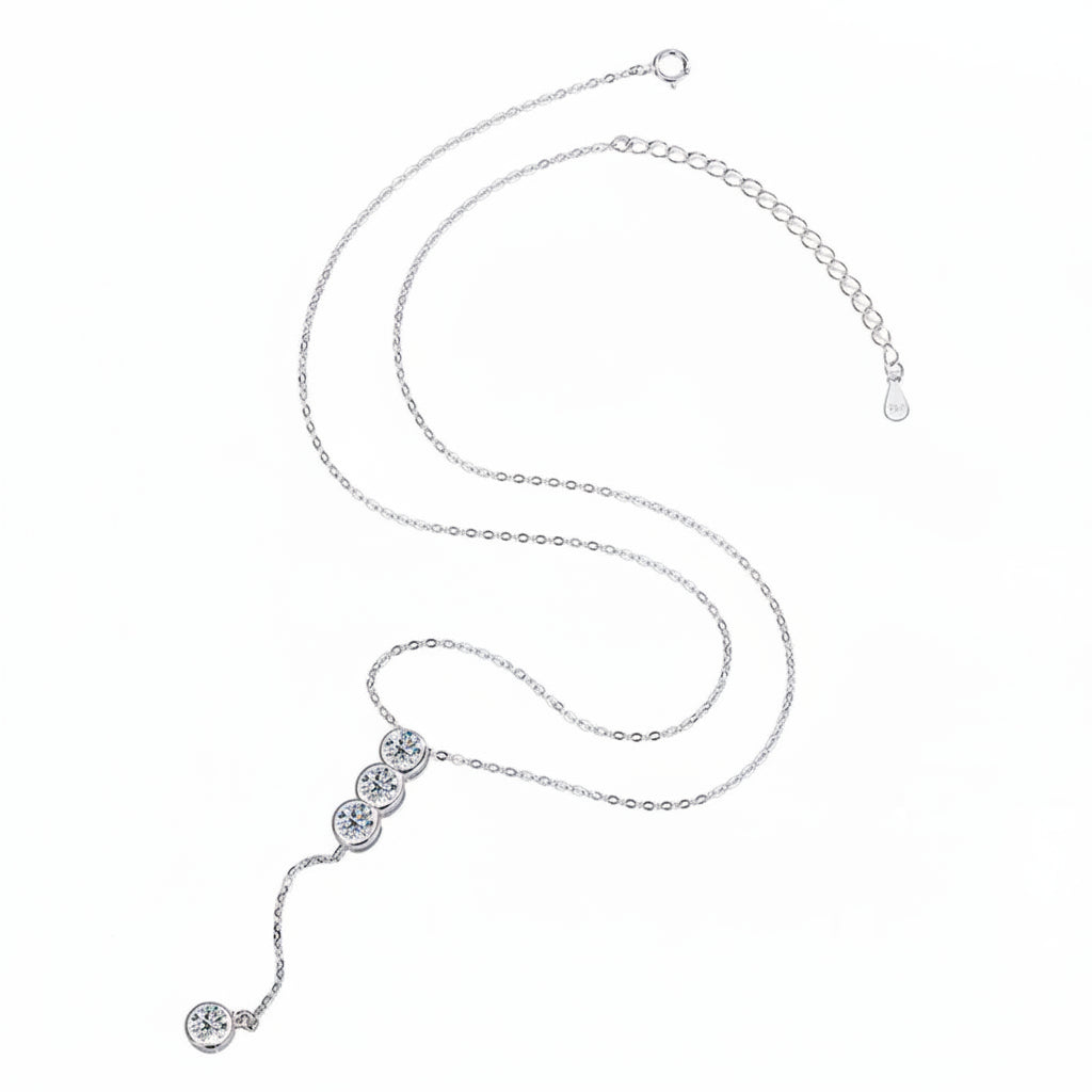 Silver necklace with four moissanite gemstones on a white background