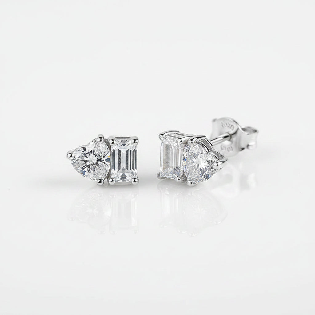 Silver stud earrings on a white surface