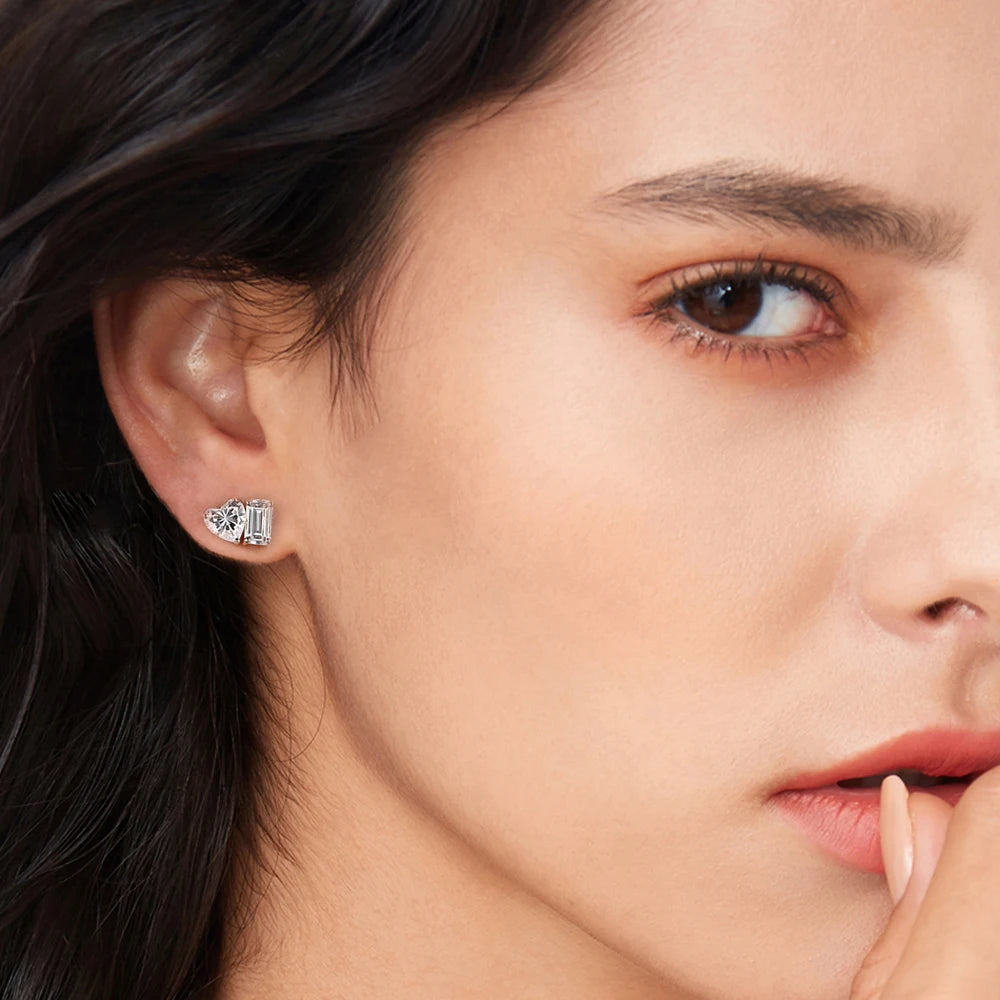 Close-up of a woman wearing diamond stud earrings.