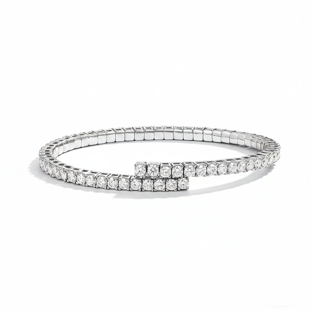 Silver bracelet with clear stones on a white surface 
