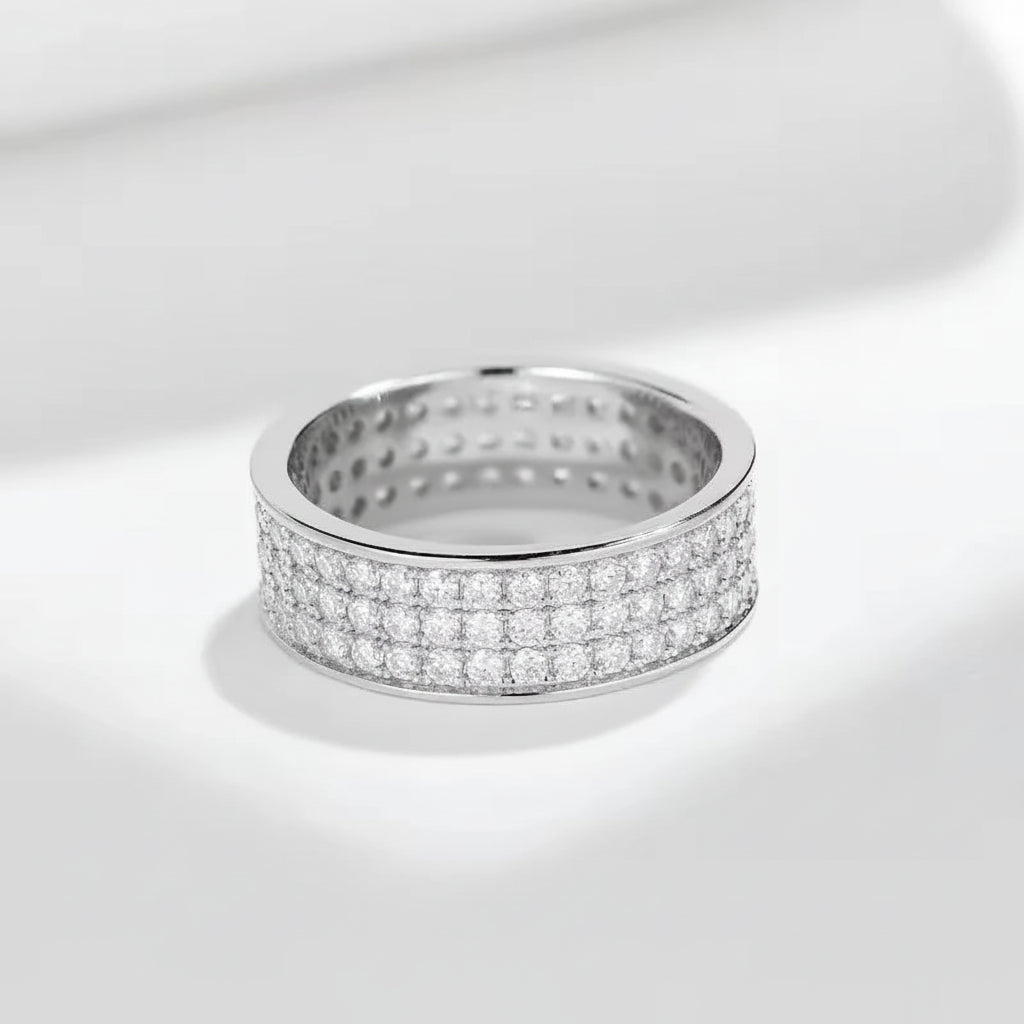 Silver ring with diamond accents on a white background