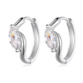 Silver hoop earrings with moissanite gemstones on a white background