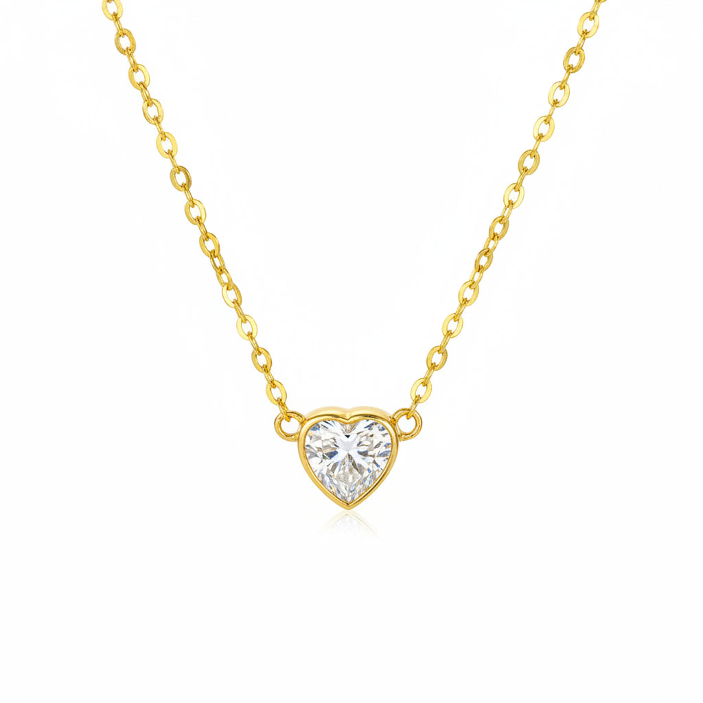 Gold necklace with a heart-shaped moissanite diamond pendant on a white background